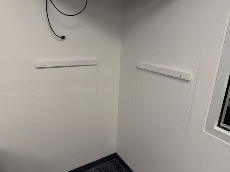 Wall brackets and cable runs prepared for an equipment shelf.